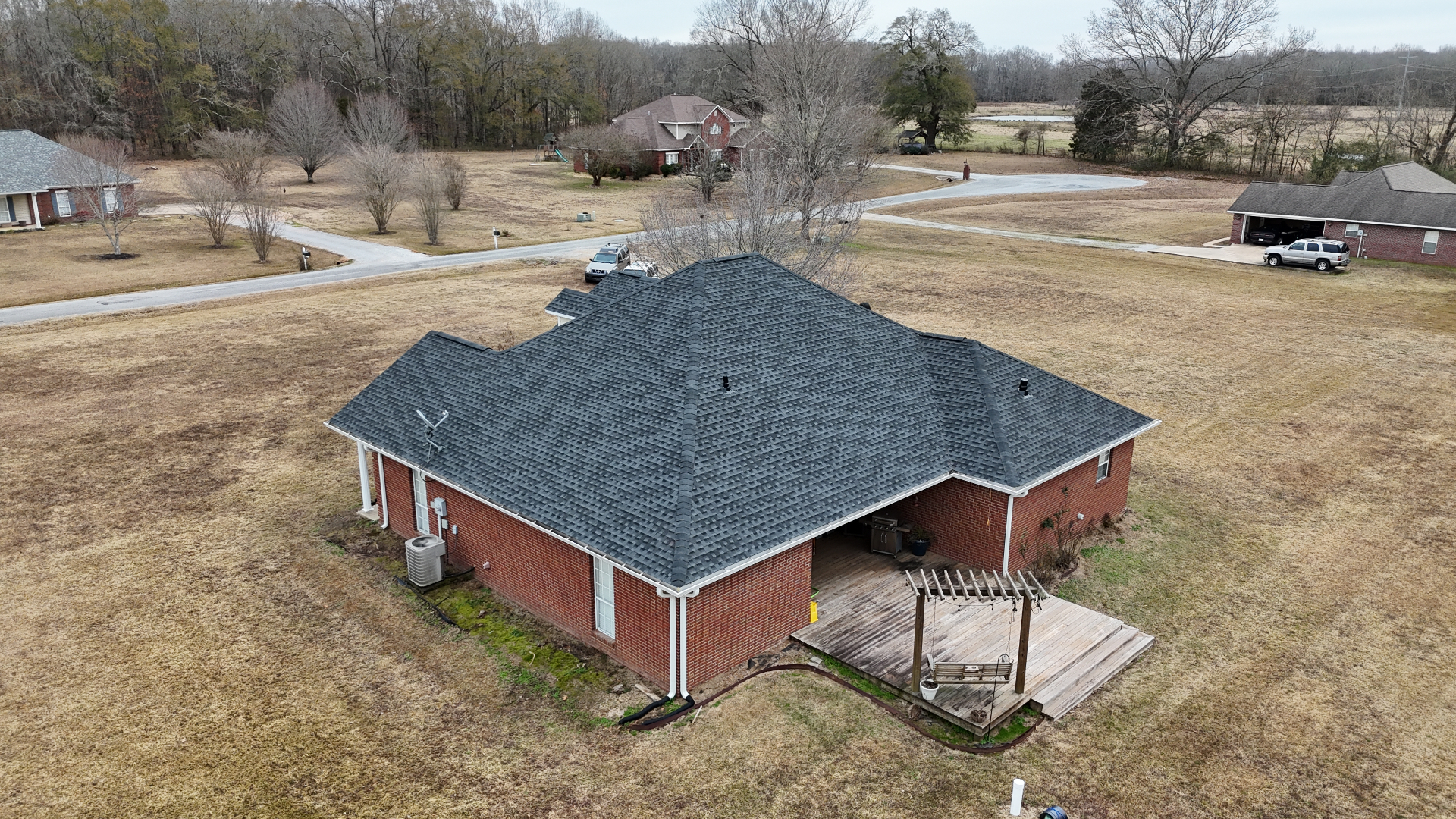 Aerial drone shot of completed charcoal shingle roof on brick ranch home in Starkville MS